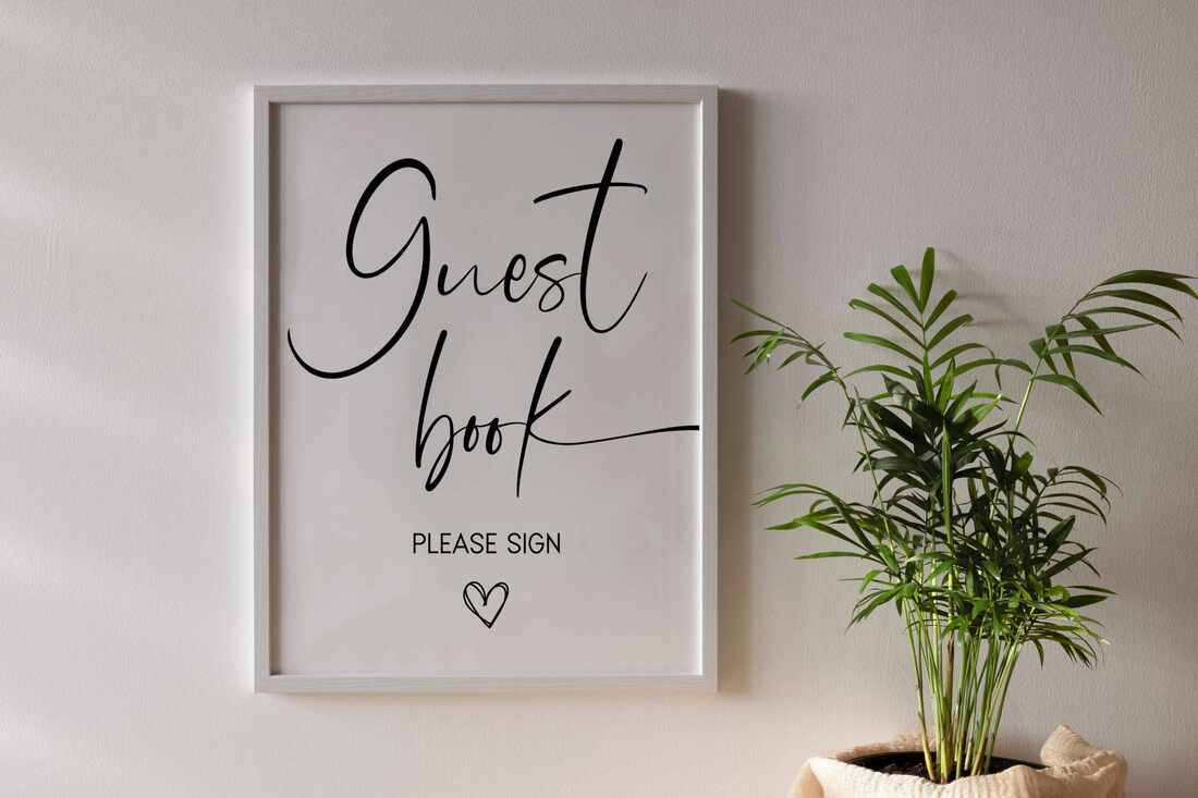 Minimalist guest book sign hanging on a wall