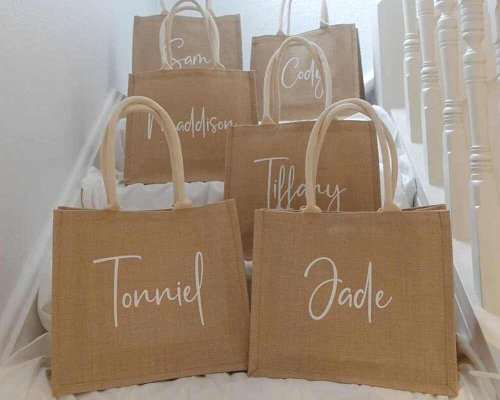 Hen Party Favour Bags Personalised with people's names. There are six of them altogether and they are placed neatly on a white staircase.