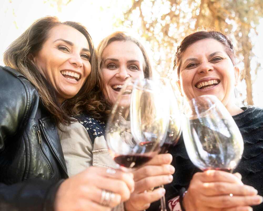 Three women drinking wine